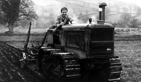 WLA recruit ploughing with a tractor. The tractor is an Allis Chalmers Model M.